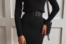a black sweater dress with a turtleneck, long sleeves, a leather belt and a square bag for a chic and comfy look