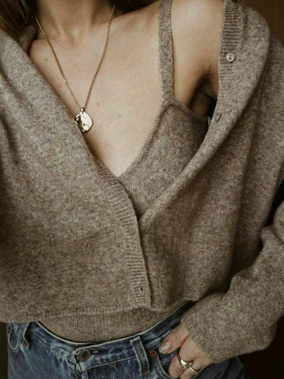 a comfortable everyday outfit of a grey knit top and a matching cardigan, blue jeans and a necklace is ideal for winter
