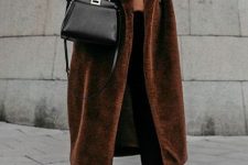 a comfortable look with a rust turtleneck, black skinnies, black booties, a brown faux fur coat and a black bag
