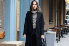 a comfortable winter look with a grey turtleneck, leather leggings, Chelsea boots, a black coat and a bag