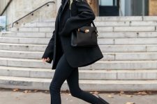a comfy total black look with a sweater, skinnies, Chelsea boots, a short coat and a bag