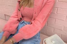a cute girlish look with a pink fluffy tank top and a cardigan, blue jeans and a white pearled bag is whimsy