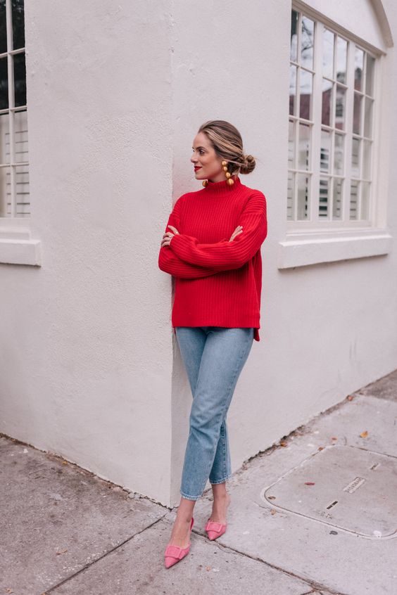 a girlish holiday look with a red sweater, light blue jeans, pink buckle shoes and statement earrings
