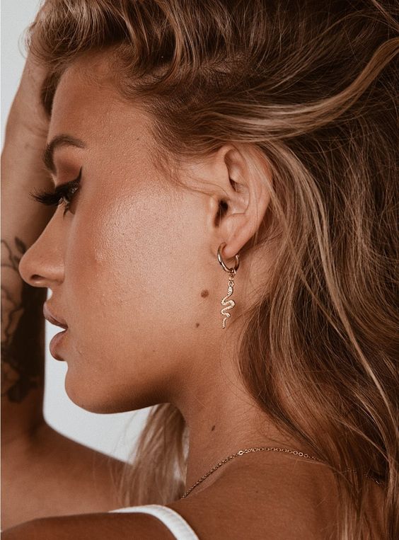a gold hoop earring with a snake is a very original and catchy idea to spruce up your look