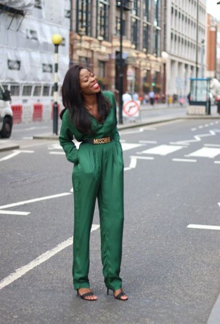 a green jumpsuit with a statement logo belt and black shoes for a gorgeous Christmas party look