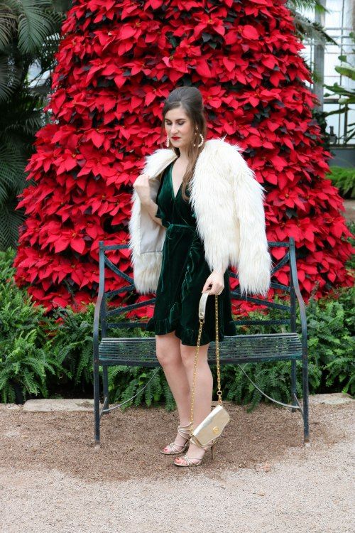 a green velvet wrap mini dress, a white fuzzy jacket, metallic shoes and a bag for a glam Christmas party