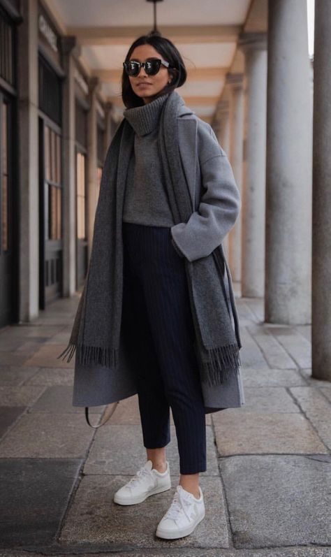 a simple outfit with an oversized grey turtleneck sweater, navy thin striped pants, white sneakers, a midi coat and a scarf
