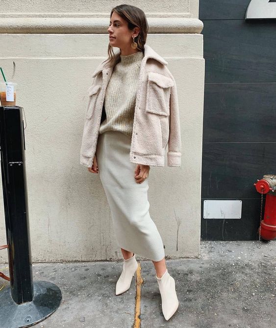 a stylish look with a neutral turtleneck sweater, a creamy pencil midi skirt, white booties and a neutral faux fur jacket