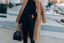 a stylish outfit with a sweater, leggings, embellished boots, a bag and a camel midi coat