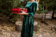 a velvet emerald fitting midi dress with a high neckline and long sleeves plus red ruffle shoes look cute