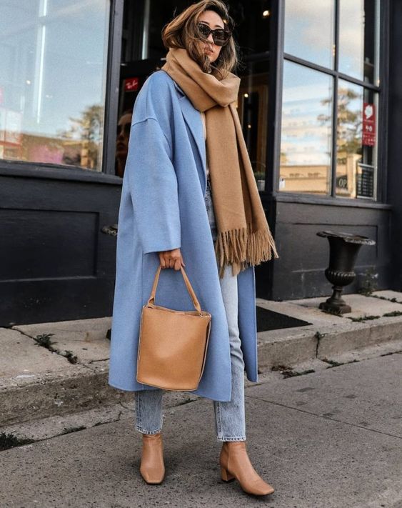 a warm beige scarf echoing the boots and the bag, blue jeans and a blue coat for a chic winter look