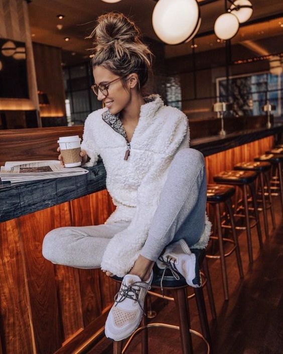 a white sherpa zip sweater, grey joggers, white and peachy trainers will be great for rocking every day