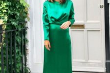 an emerald silk midi dress with a wrapped bodice and long sleeves plus metallic shoes
