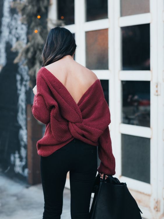 black jeans, a burgundy sweater with a knotted cutout back and some black booties for a statement