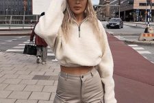 grey cargo pants, a white fuzzy zip sweater, a white cap for a sporty and chic look