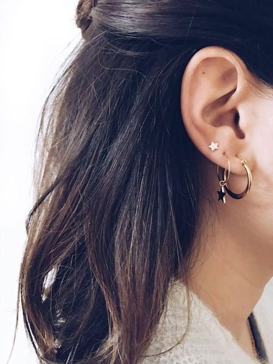 multiple earrings in gold styled with stars look matching and very chic, will match most of your looks