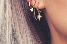 small gold hoop earrings with star and geometric pendants and a stud with a chain look wow