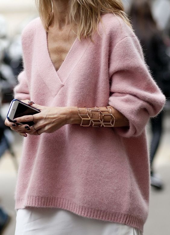 an oversized pink cashmere sweater, a white skirt and a statement rose gold bracelet for winter