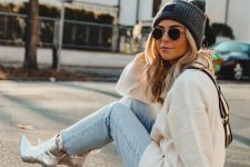 With gray hat, white hoodie and cropped jeans