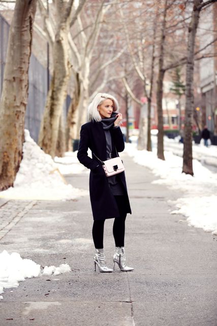 With gray sweater dress, black coat and white chain strap bag