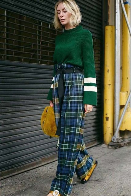 With green and white sweater, green belt, yellow fur bag and flat shoes