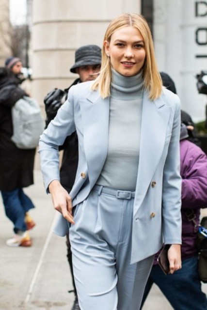 With light blue blazer and high-waisted trousers