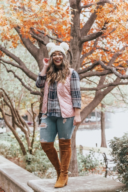 With plaid button down shirt, pale pink puffer vest, distressed jeans and brown suede boots
