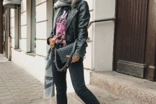 With t-shirt, black leather jacket, dark colored jeans, black bag and gray scarf
