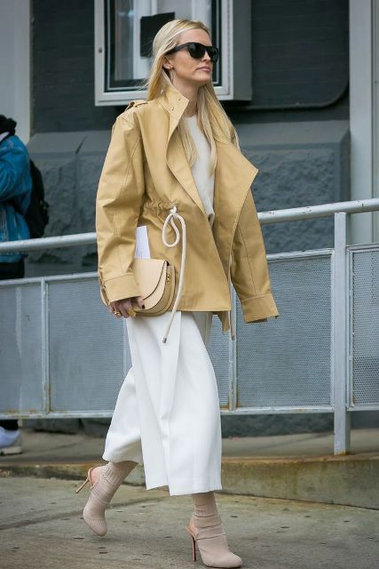 With white shirt, white culottes, beige bag and beige belted jacket
