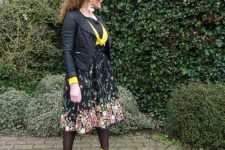 With yellow and black shirt, floral skirt and black jacket