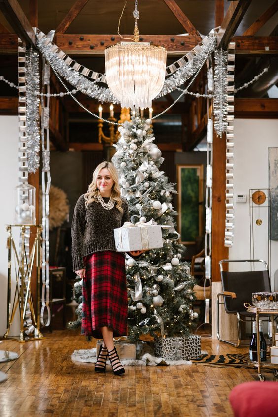 a black shiny sweater, a plaid midi skirt, black strappy shoes and a layered necklace for a lovely and chic look
