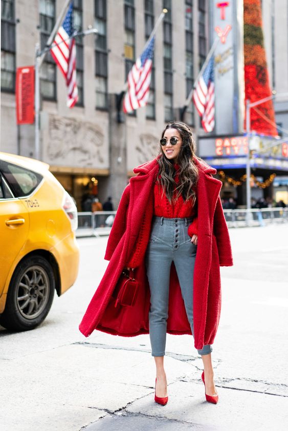 a bold holiday look with a red sweater, high waisted blue skinnies, red shoes, a red faux fur coat and a red bag