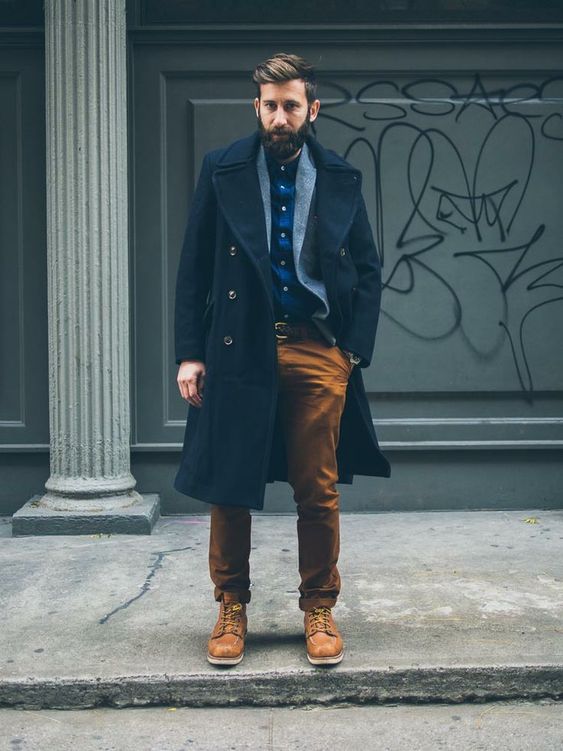 a bright winter outfit with a blue plaid shirt, a cardigan, a navy coat, rust-colored pants and boots is cool