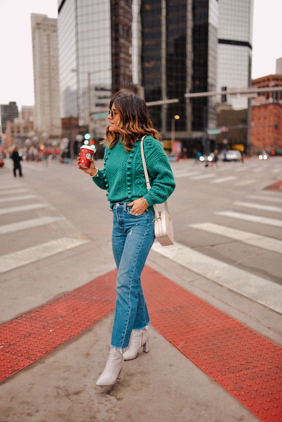 a light green pompom sweater, light blue jeans, white booties and a neutral bag for those who prefer lighter shades