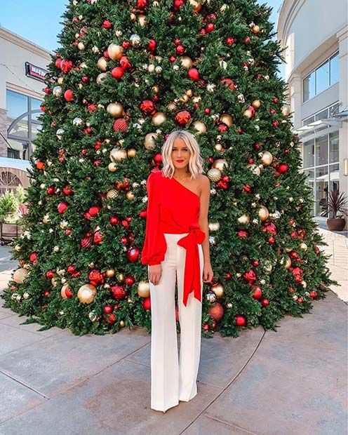 a red one shoulder top with a long sleeves, a bow and white pants for an elegant and very refined holiday look