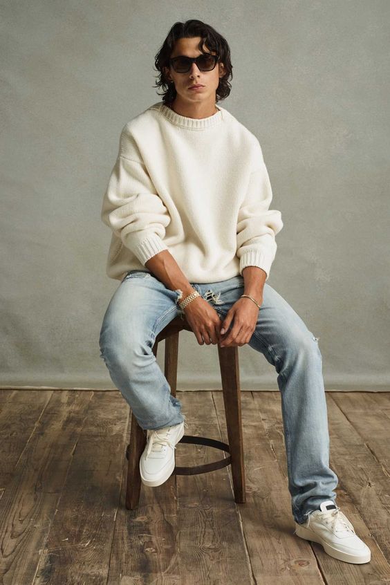 a relaxed look with an oversized white high neck sweater, light blue jeans and white sneakers is very cozy