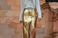a white fuzzy sweater with embroidery, a gold sequin midi with a front slit and gold shoes for a glam look