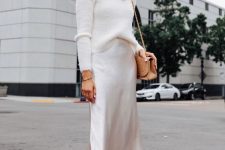 a white outfit with a turtleneck sweater, a slip midi skirt, nude shoes and a bag is very elegant