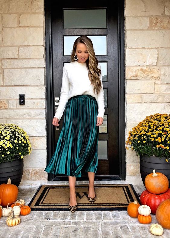 a white sweatshirt, a hunter green pleated midi skirt, leopard print shoes for a simple and stylish holiday look