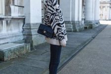 a zebra print sweater, navy skinnies, tan booties and a black bag for a bold and trendy winter outfit