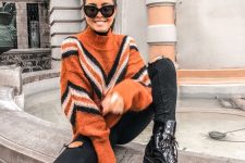 an orange geometric turtleneck sweater, black ripped jeans, black boots for a bold and pretty outfit