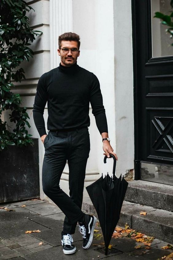 grey pants, a black turtleneck and black sneakers for a monochromatic and chic Christmas outfit
