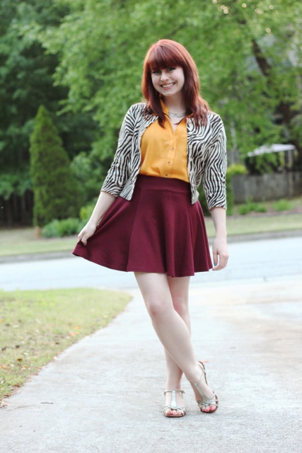 With orange shirt, marsala mini skirt and flat shoes
