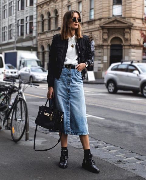 With white t-shirt, black bag, black bomber jacket and black mid calf boots