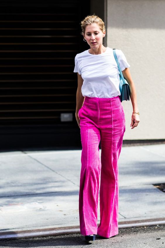 a simple and bold look with a white tee, hot pink corduroy pants, platform shoes and a blue mini bag