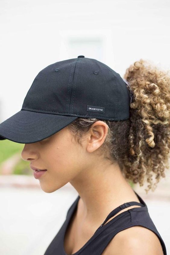 a baseball cap and a high curly ponytail tucked in are a lovely solution that is comfy in wearing
