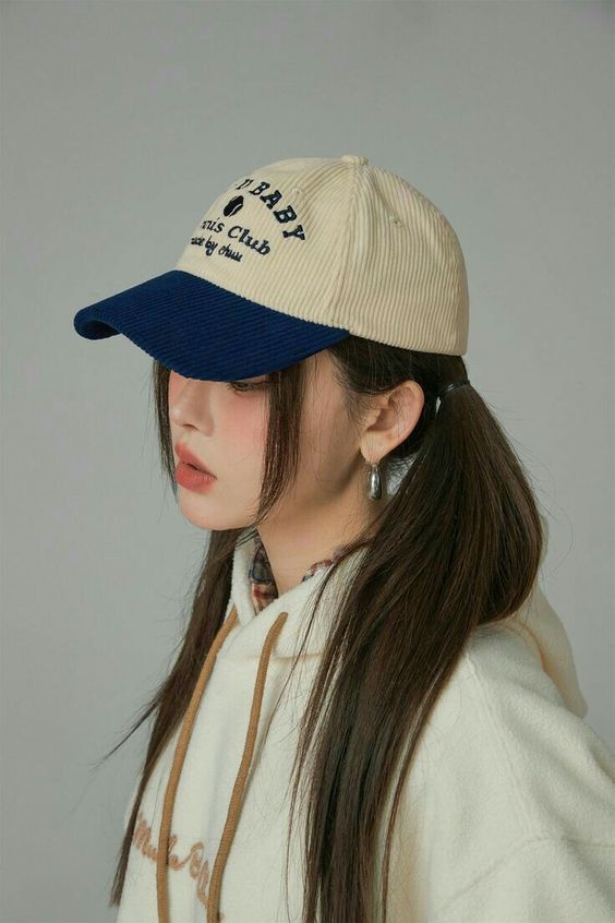 A baseball cap, low ponytails and face framing hair create a super cute and lovely look
