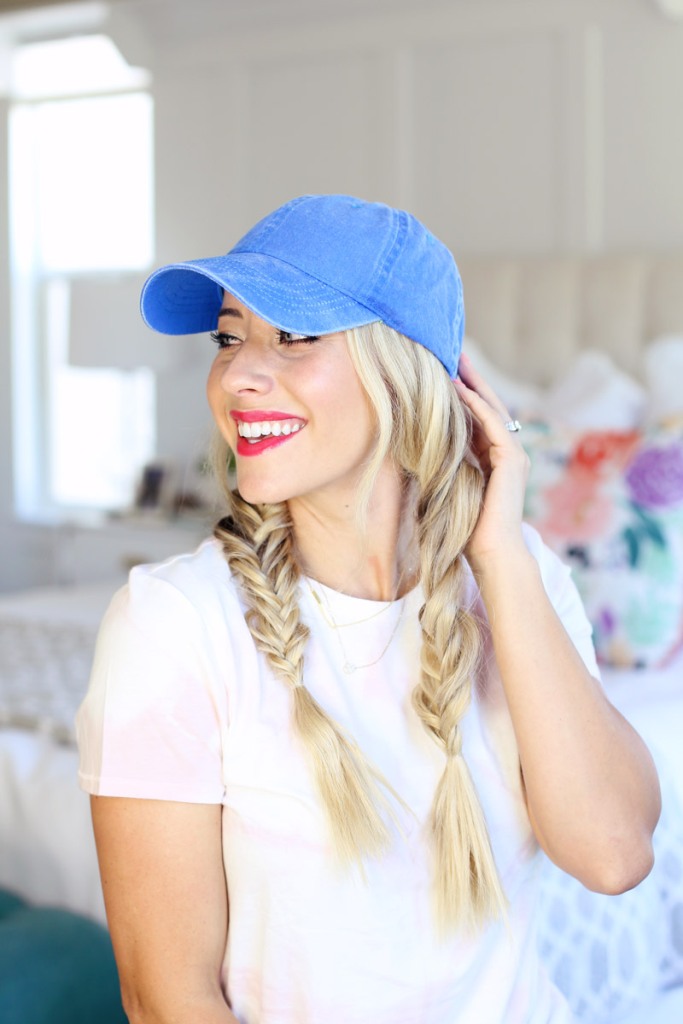 a baseball hat plus fishtail braids are a veyr comfy combo, and your hair will look great here