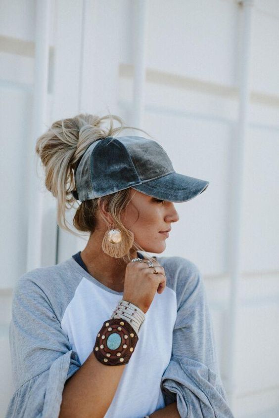 A blue baseball cap paired with a messy top knot and some face framing hair is a lovely idea