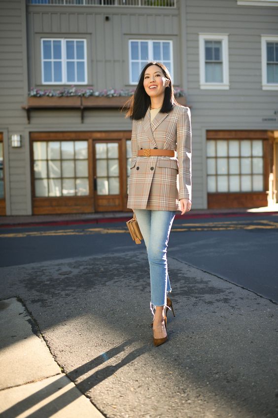 a classic work look with a neutral tee, a plaid oversized blazer, blue skinnies, brown shoes and a brown clutch